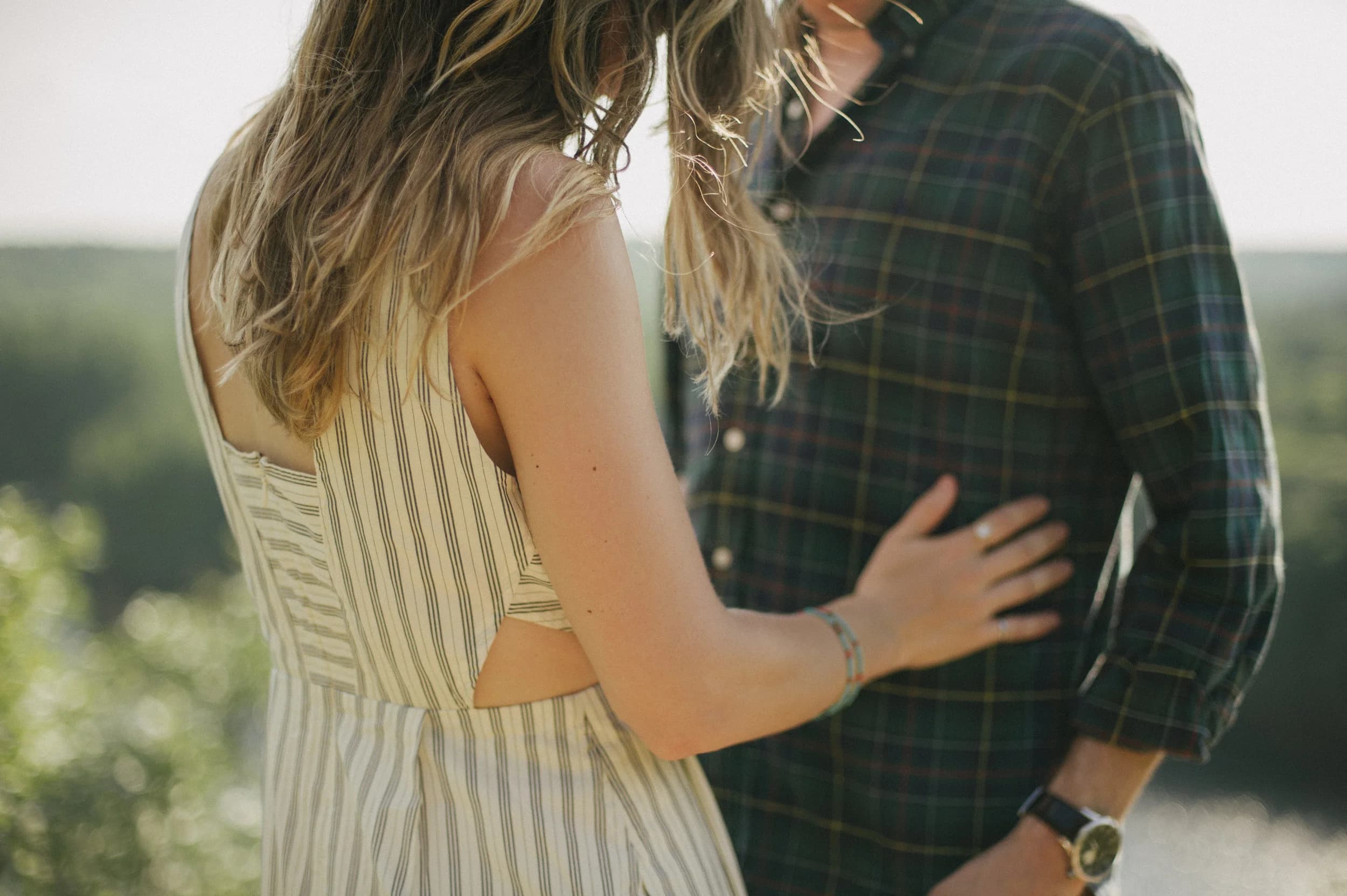 Close-up of the couple embracing outdoors.
